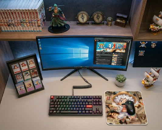 Modern One Piece anime gaming setup featuring Gear 5 Luffy themed mouse pad, RGB mechanical keyboard, ultrawide monitor, manga collectibles, and clean desktop workspace aesthetic