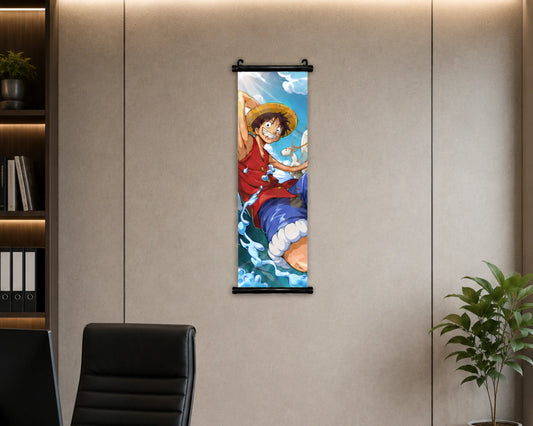 A vertical anime wall scroll featuring Monkey D. Luffy from One Piece, displayed on a beige paneled wall in an office setting with a desk chair and plant visible.