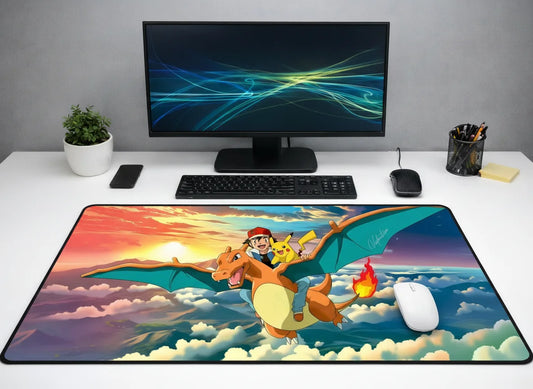 Large 24x12 inch Pokémon mousepad featuring Ash and Pikachu riding Charizard through a colorful sunset sky over the clouds.