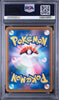 A graded PSA PSA+ Pokémon card in a clear plastic grading slab, featuring a blue and multicolor Pokémon card back with a central Pokémon Ball design.