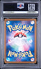 A graded Pokémon card in a PSA protective slab. The card features a colorful blue and pink background with a Pokéball in the center and the word 'Pokémon' in large yellow letters at the top and bottom.