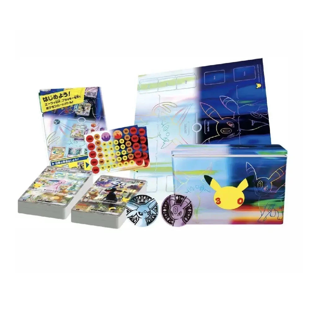 Pokémon TCG trading card set packaging and contents displayed on a white background, including a large illustrated box with Pikachu artwork, card decks, a circular disc, a small booklet, and a grid of colored circular pieces.