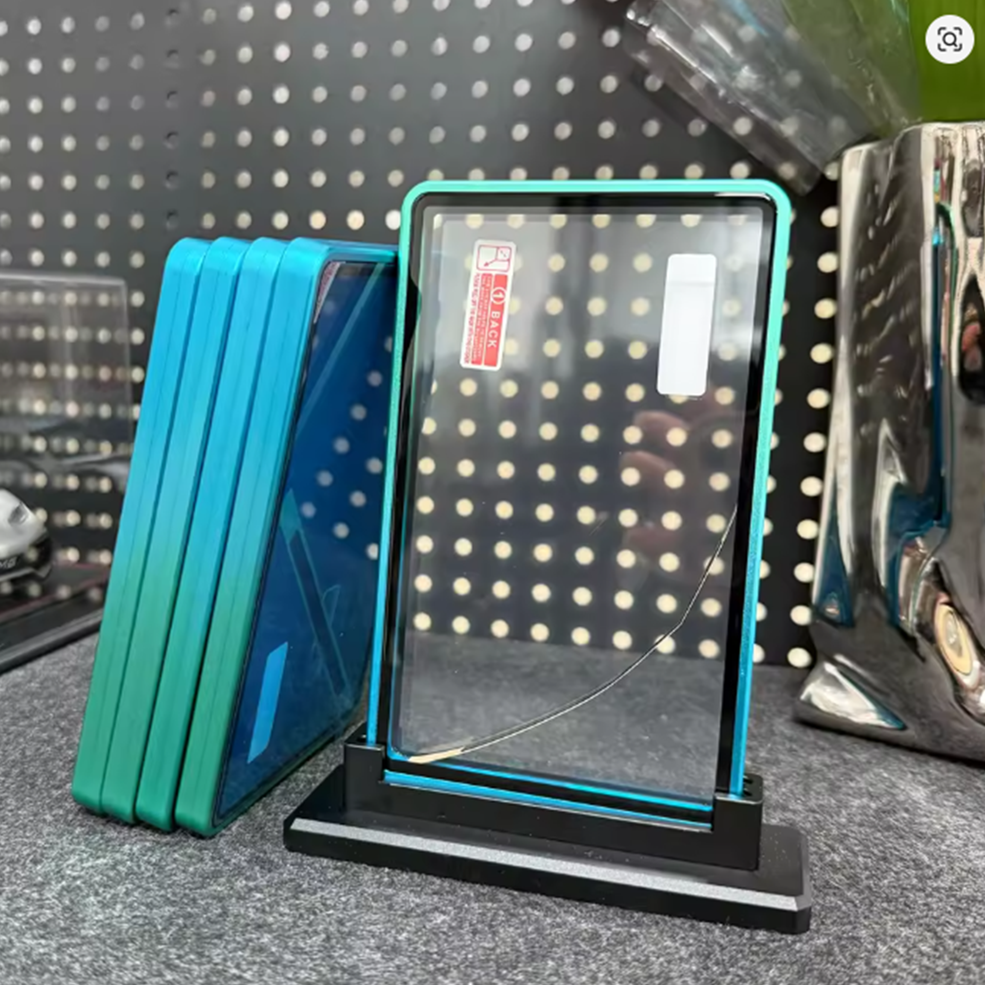 LED light panel on a stand with blue border against a pegboard background