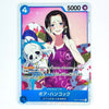A character trading card featuring an illustrated woman with long dark hair in a purple dress and a blue skull-like creature, with card stats and Japanese text visible on a pink and blue card face.