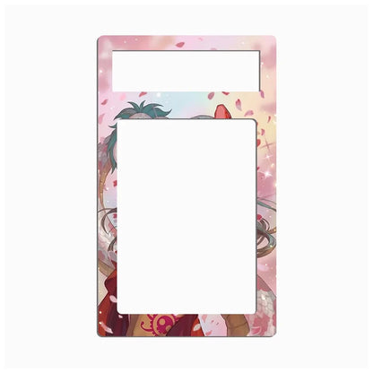 A decorative rectangular frame or mat with rounded corners, featuring an anime-style illustration in pastel pink, peach, and cream tones with cherry blossom petals and a character motif. The center and top sections are blank white, suggesting a placeholder for photos or cards.