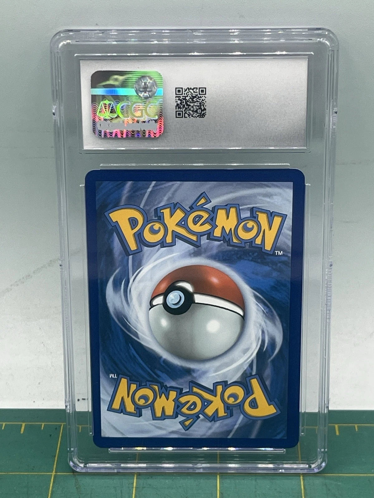 Pokémon trading card in a protective case on a white background