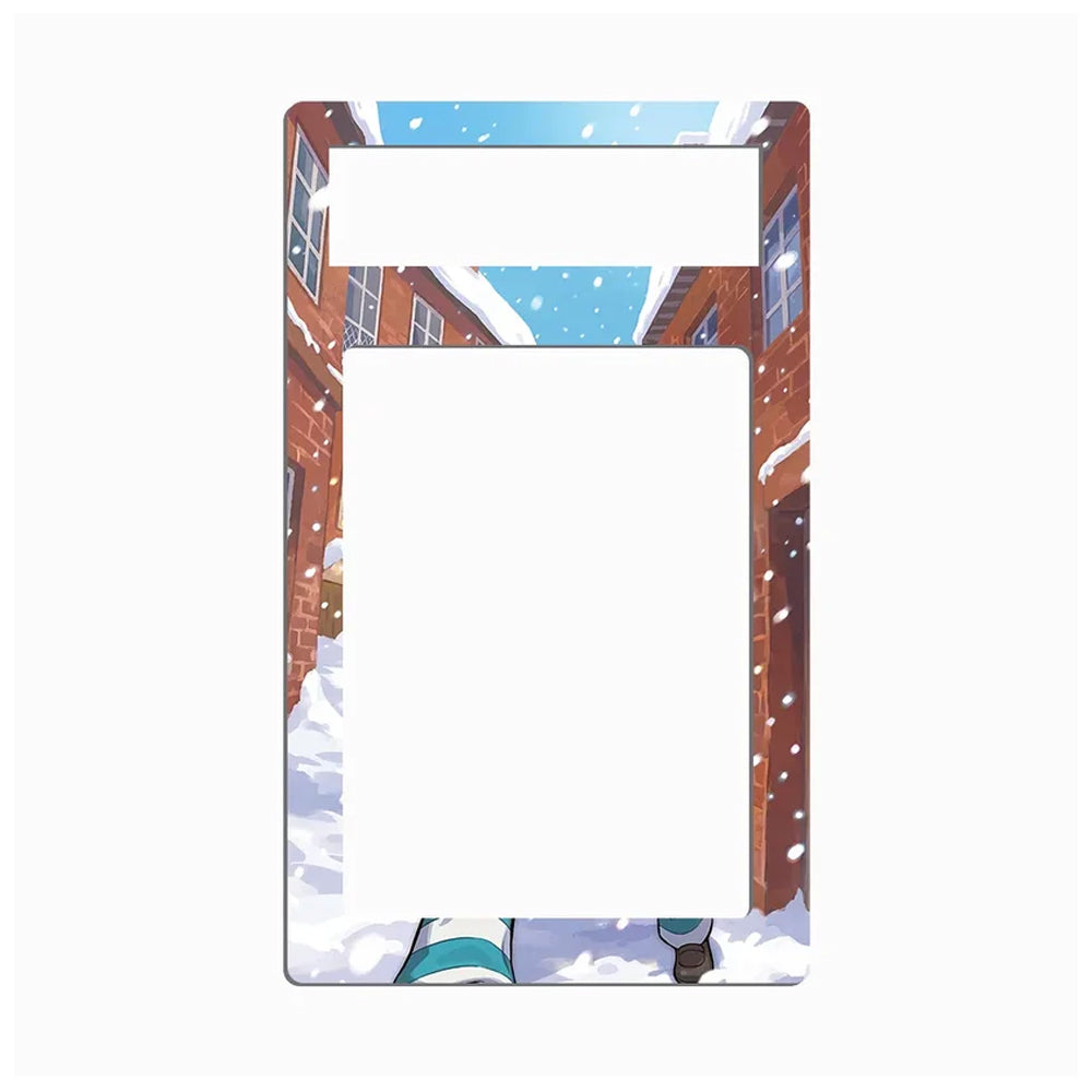 A rectangular picture frame with rounded corners, featuring an anime-style winter scene printed on the border. The illustration shows snow-covered brick buildings, falling snow, a blue sky, and a small character at the bottom.