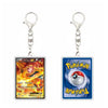 Two Pokémon-themed acrylic keychains shown side by side on a plain white background. The left keychain features a Charizard card print with a silver clasp, and the right keychain features a blue Pokémon card with a red-and-white Pokéball graphic and yellow logo.