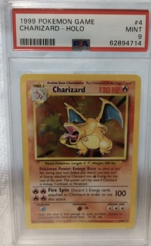 1999 Charizard Pokémon trading card with holographic effect in a protective case.