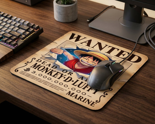 Close-up of Monkey D. Luffy wanted poster style anime mouse pad with gaming mouse on dark wood desk, featuring vibrant One Piece artwork and cozy desktop setup