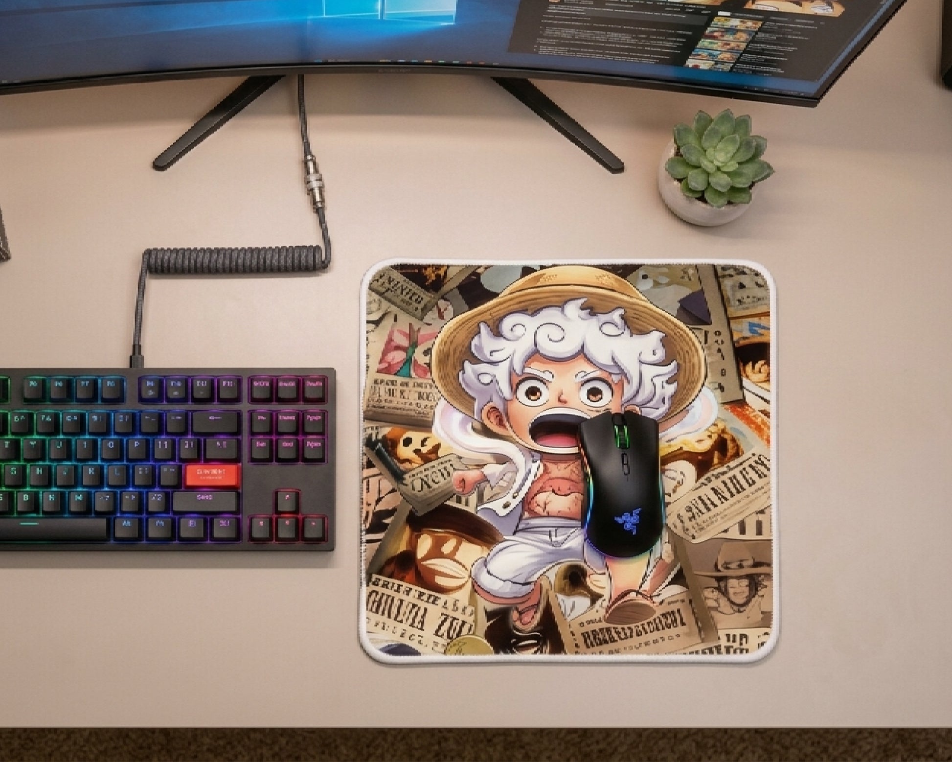 Cute chibi Gear 5 Monkey D. Luffy anime mouse pad with wanted poster collage background, placed beside RGB gaming mouse and mechanical keyboard on minimalist desk setup
