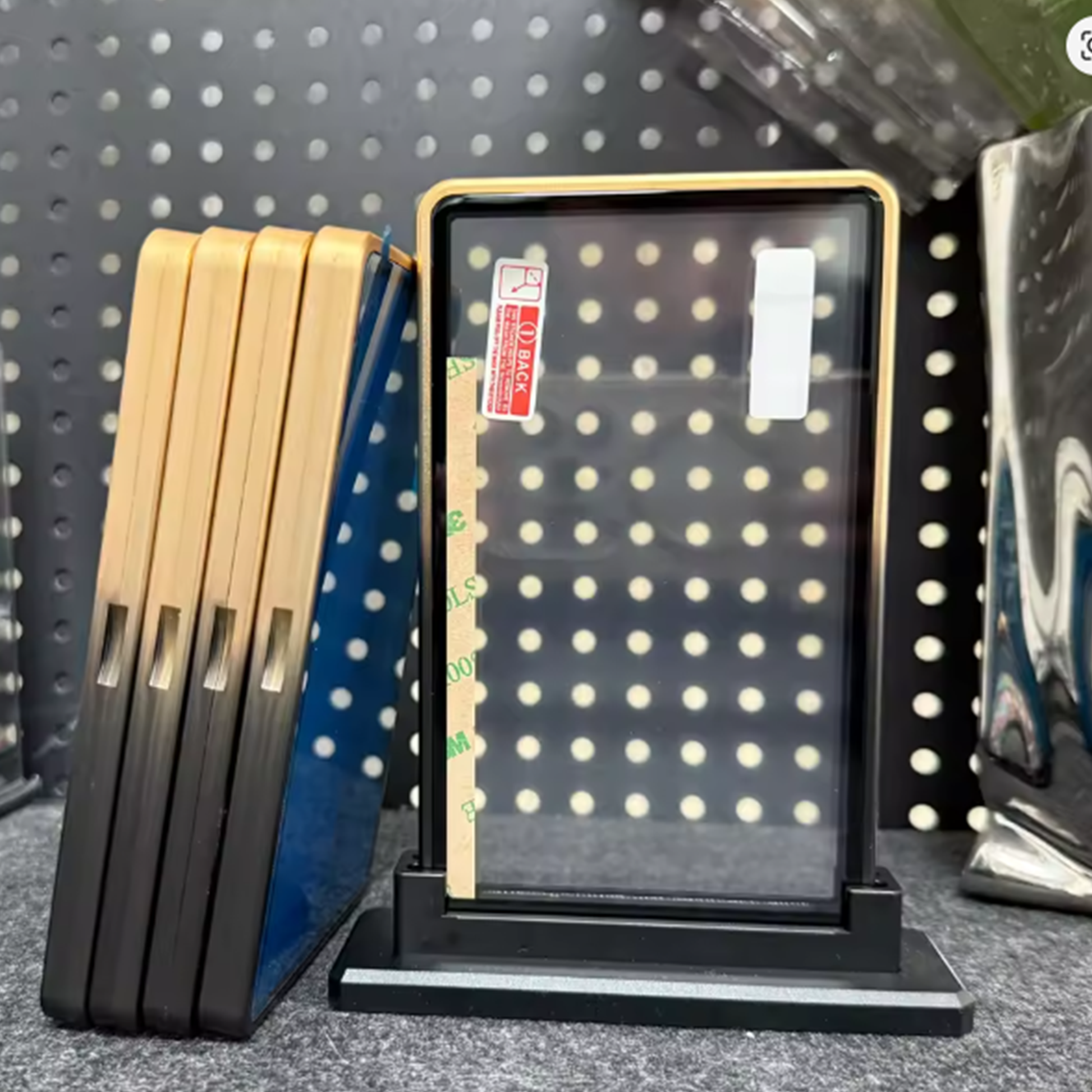 Display stand with pegboard and wooden dividers against a pegboard background