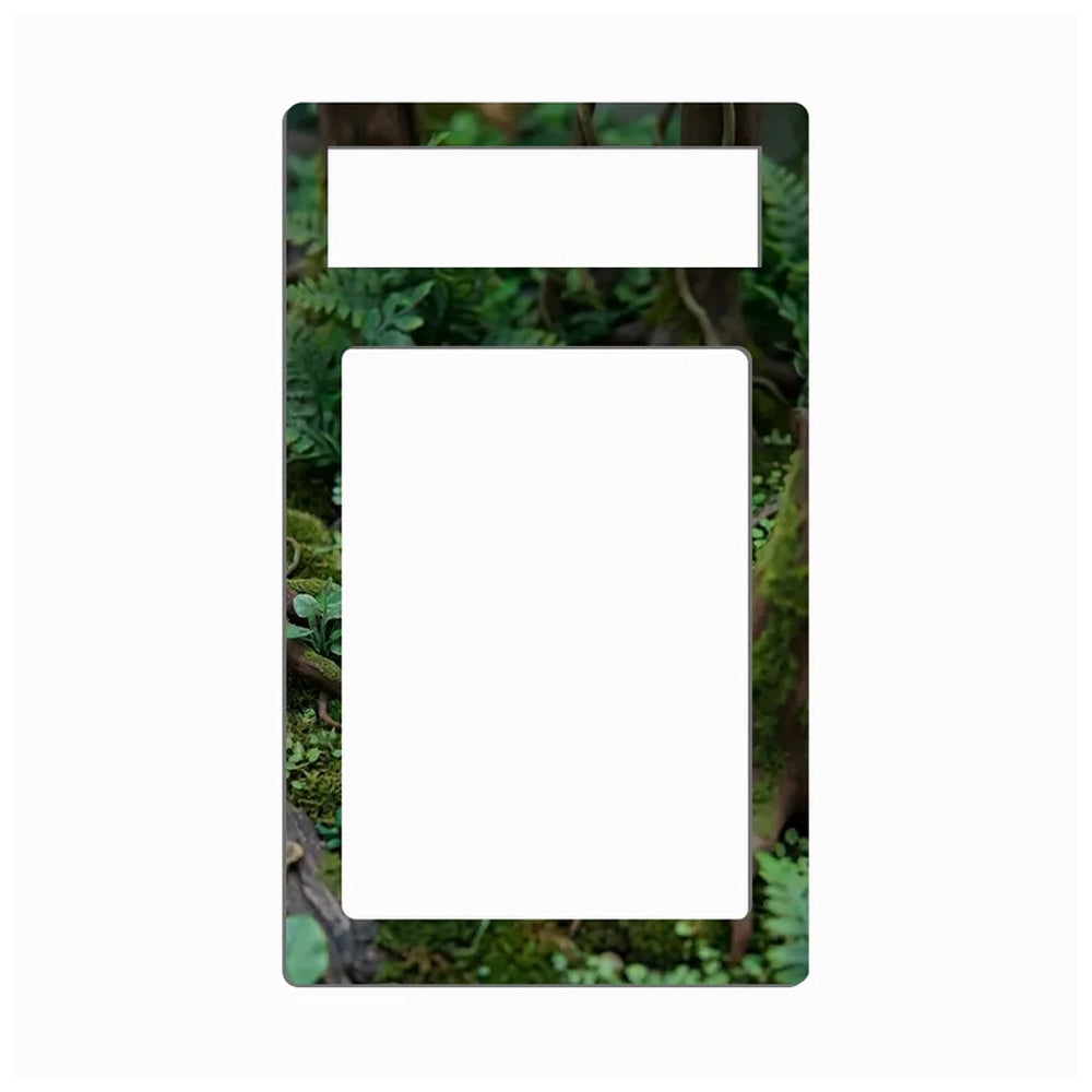 A rectangular light switch plate cover featuring a green mossy forest background, with a top horizontal slot and a larger vertical slot cutout in the center, shown on a plain white background.