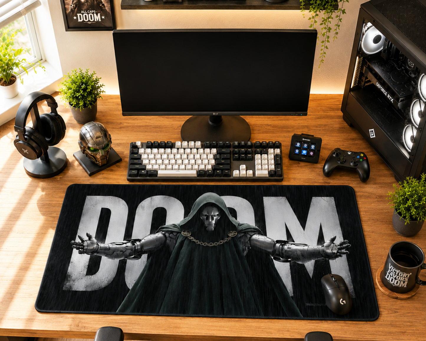 A large black gaming desk mat featuring a printed graphic of a hooded grim reaper with outstretched hands and the word 'DOOM' in large white letters, styled on a wooden desk with a keyboard, mouse, headset, and computer setup.