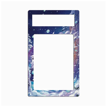 A decorative phone case frame or card holder insert with a printed winter fantasy design, featuring a dark blue starry sky, snowy mountains, and purple clouds on a white background.