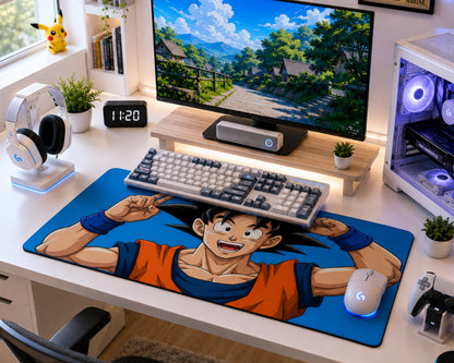 A large desk mat featuring an anime character print in orange and blue, styled on a white desk with a keyboard, mouse, monitor, and gaming accessories.