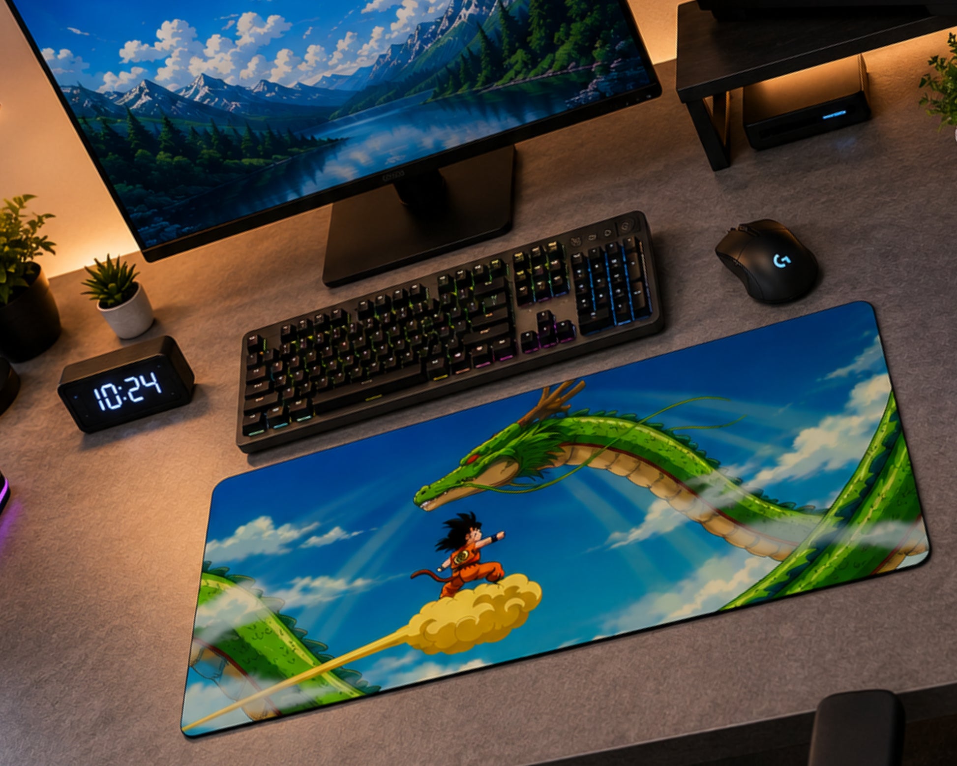 A large desk mat featuring a colorful Dragon Ball Z illustration with Goku on a cloud and a green dragon, placed on a gray desk next to a keyboard, mouse, and computer monitor.