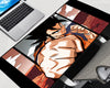 Dragon Ball Z Goku gaming mouse pad featuring a dramatic manga-style close-up of Goku throwing a powerful punch, with black panel borders and orange-red anime artwork.