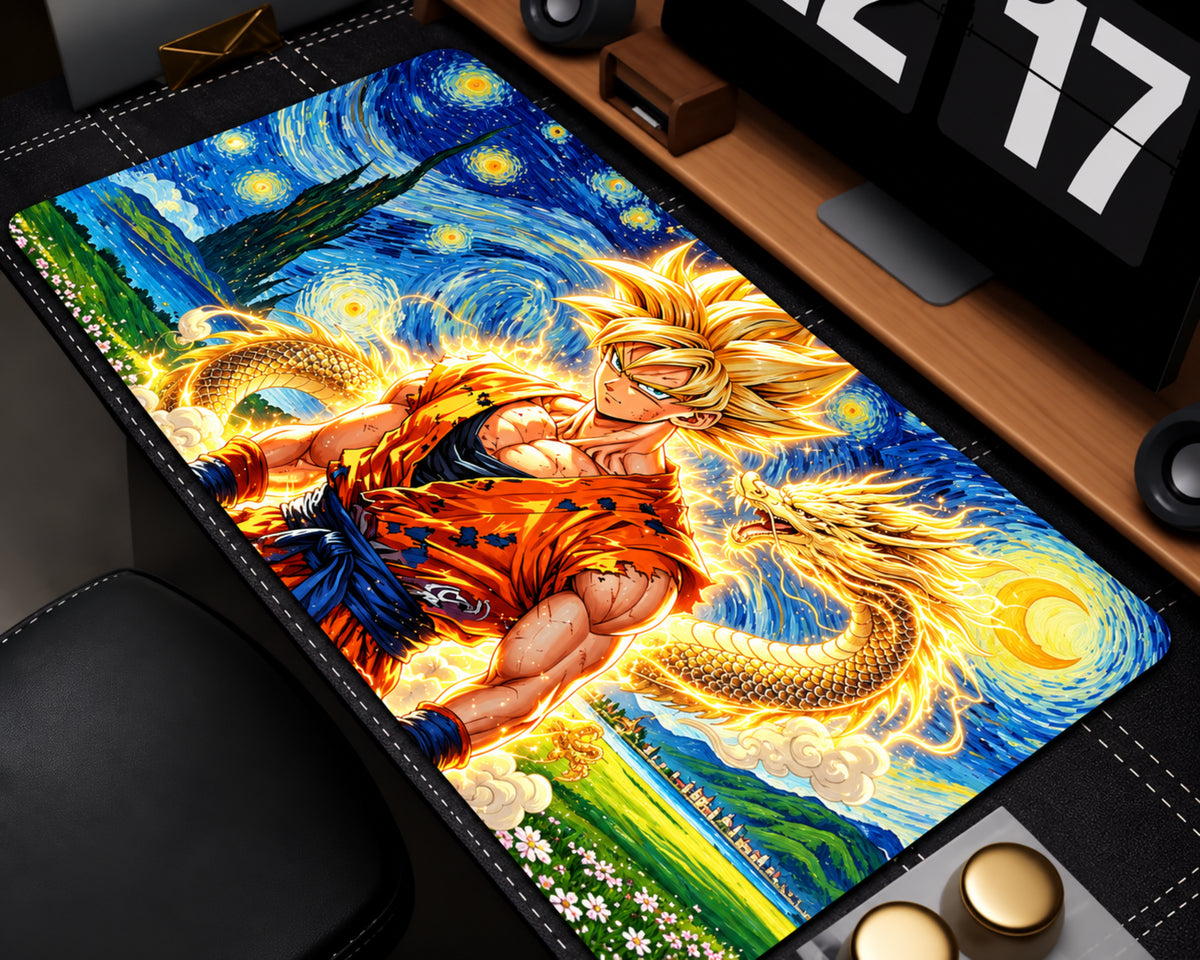 A rectangular desk mat featuring a colorful anime-style print of Goku in an orange gi against a swirling blue and yellow Starry Night-inspired sky, with a dragon motif. The mat is shown laid out on a desk near a monitor and keyboard.