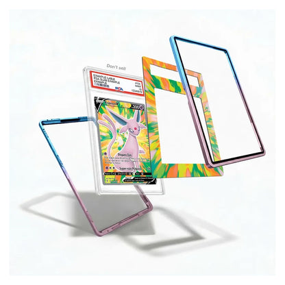 Three clear protective phone cases with colorful metallic borders are displayed on a white background, with one case holding a graded Pokémon Eevee card.
