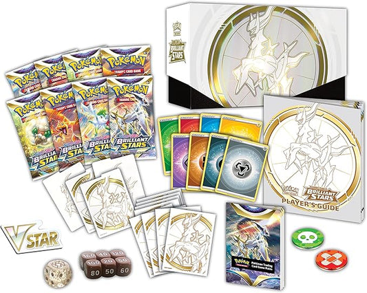 Pokémon trading card game set with cards, dice, and guidebook on a white background