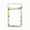 A decorative rectangular frame or mat with rounded corners, featuring a pastel landscape border and floral accents around the edges, with a large blank white center and a smaller blank white top section.