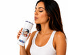 A woman in a white ribbed tank top holds a white insulated tumbler with a straw and a Dragon Ball Z anime graphic, set against a solid white background.