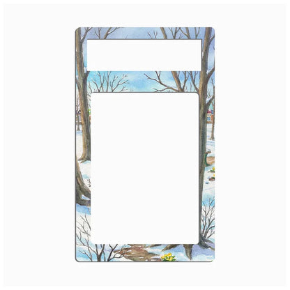 A rectangular metal plate with a single cutout, featuring a winter landscape illustration of bare trees in snow under a light blue sky.