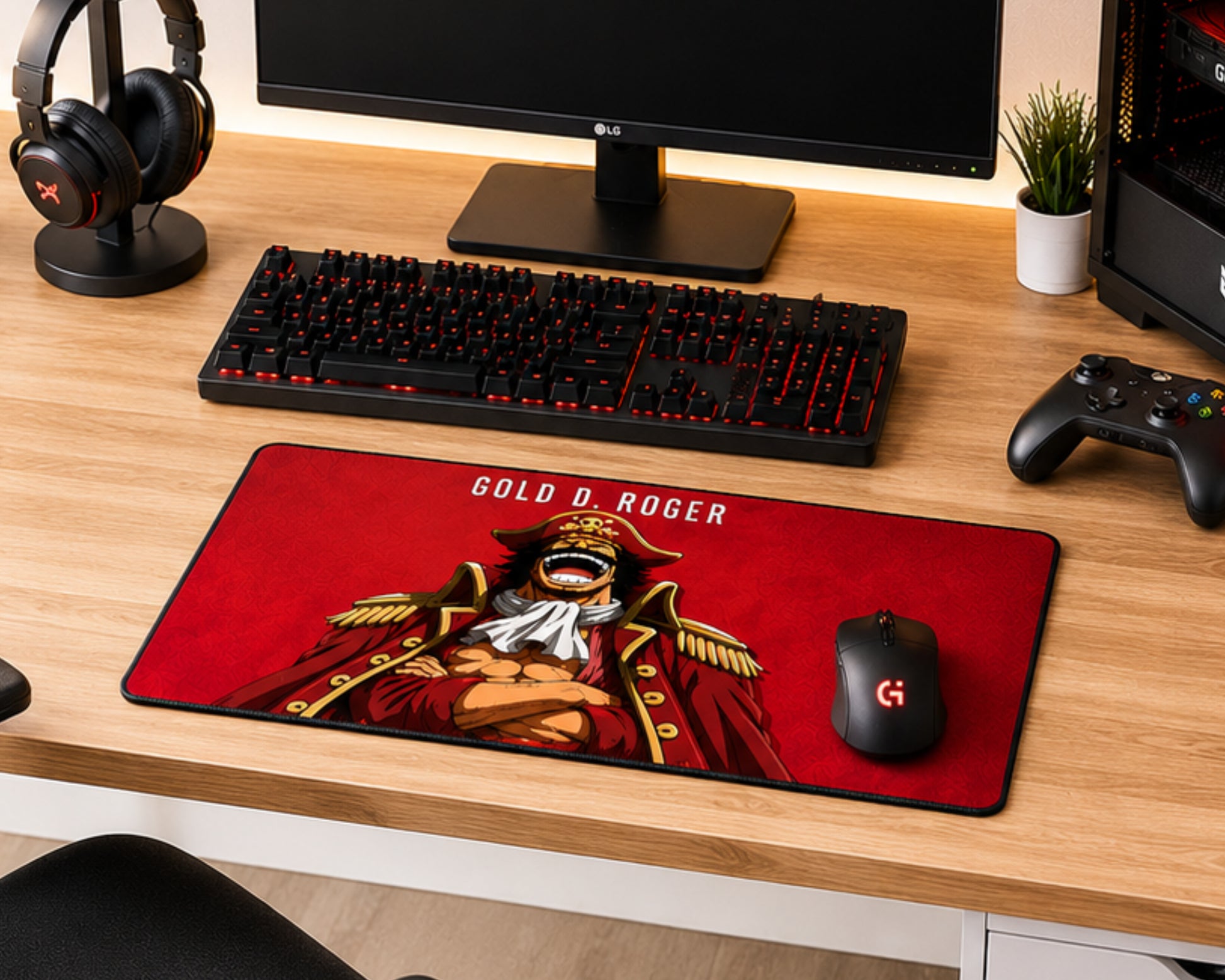 A large gaming desk mat featuring an anime-style illustration of Gold Roger from One Piece on a red background, styled on a wooden desk alongside a keyboard, mouse, headphones, and controller.