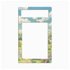 A decorative picture frame with a colorful anime-style landscape border featuring a blue sky, white clouds, green hills, and stone structures, shown on a plain white background.