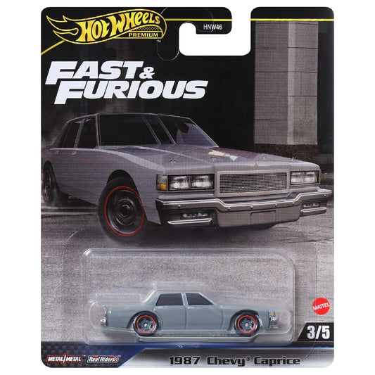 Hot Wheels Premium Fast & Furious 1987 Chevy Caprice 1:64 scale die-cast collectible car in grey with black wheels and red rim accents, featuring a classic American sedan design, Metal/Metal construction, Real Riders tires, and original Mattel blister packaging, series 3/5.
