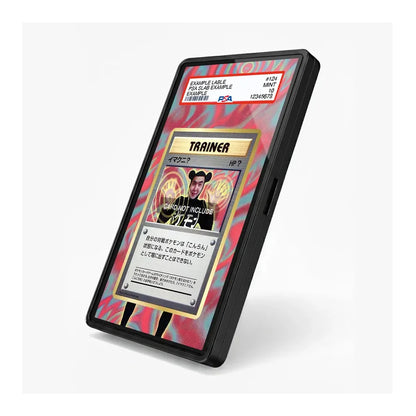 A black rectangular electronic device, resembling a portable card reader or scanner, shown standing on its edge against a light gray background. The screen displays a colorful interface with a Japanese card design featuring the text 'TRAINER' and 'GOD'S NOT GIVING'.
