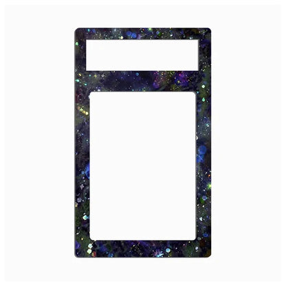 A rectangular decorative frame or plate with rounded corners, featuring a dark galaxy print with purple, blue, green, and gold glitter speckles. The top section has a smaller horizontal slot, and the lower section is a larger vertical slot, both filled with a solid white insert, set against a plain white background.