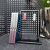 Set of makeup palettes with a polka dot design on a gray surface.