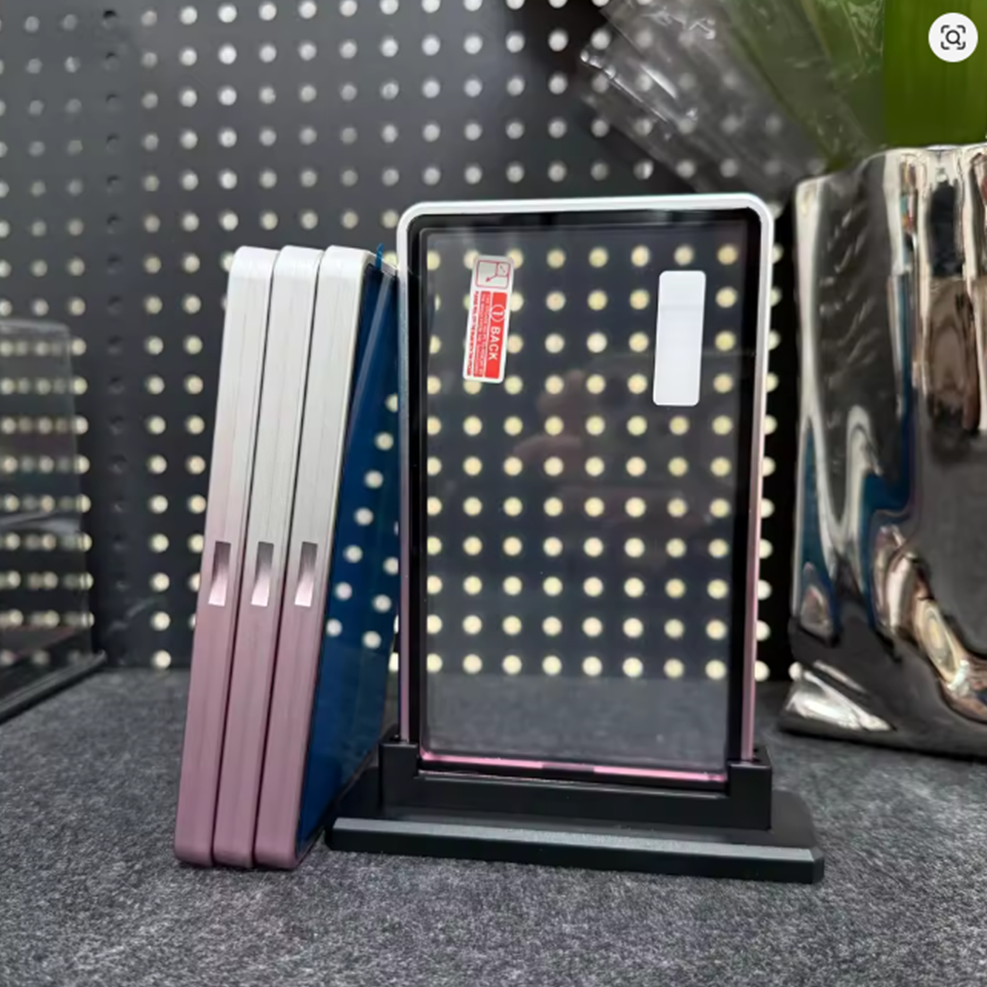Set of makeup palettes with a polka dot design on a gray surface.
