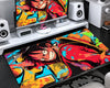 Extended gaming mouse pad featuring Luffy wearing a straw hat and red outfit, with bold black outlines and colorful red, turquoise, yellow, and orange comic-style artwork.