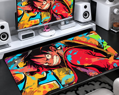 Extended gaming mouse pad featuring Luffy wearing a straw hat and red outfit, with bold black outlines and colorful red, turquoise, yellow, and orange comic-style artwork.