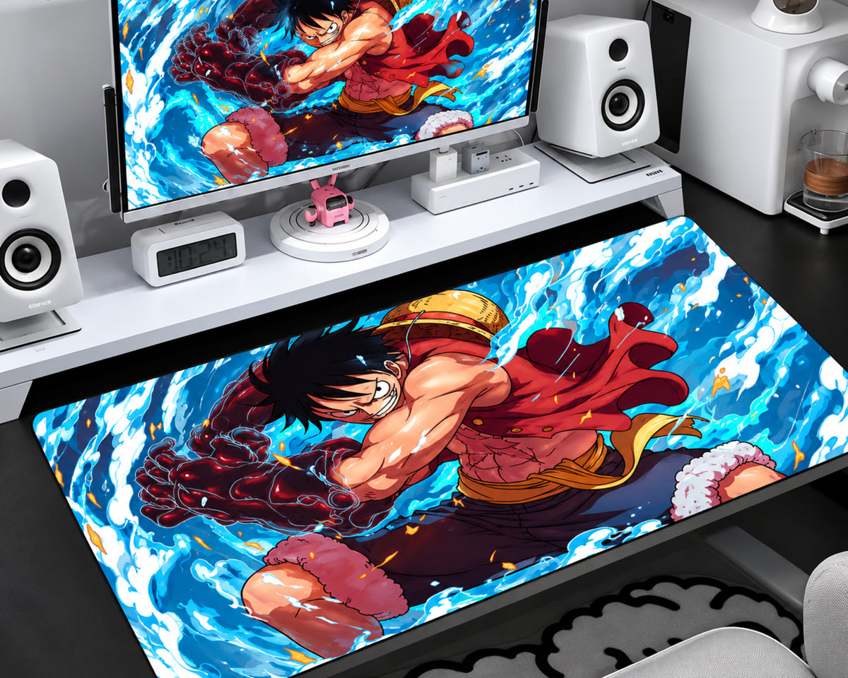 Extended gaming mouse pad featuring Luffy in a red outfit with a powerful dark fist, surrounded by vibrant blue and white swirling water effects and dynamic anime artwork.