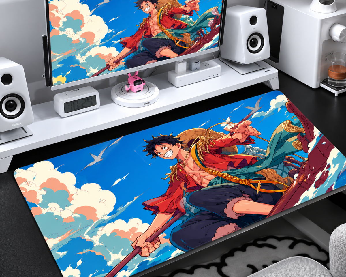 Luffy-inspired One Piece gaming mouse pad featuring a straw-hat pirate character in a red jacket and dark trousers against a vivid blue sky with white and peach clouds.