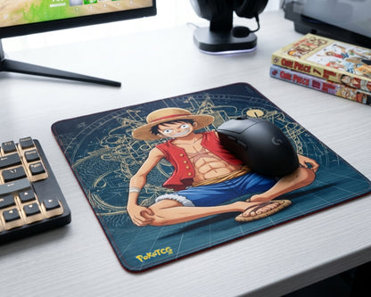 One Piece Luffy anime mouse pad in modern gaming desk setup with RGB accessories, manga books, and gaming headset
