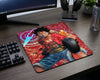 One Piece Monkey D. Luffy anime mouse pad on a modern gaming desk setup with mechanical keyboard, gaming mouse, headphones, and dark wood aesthetic