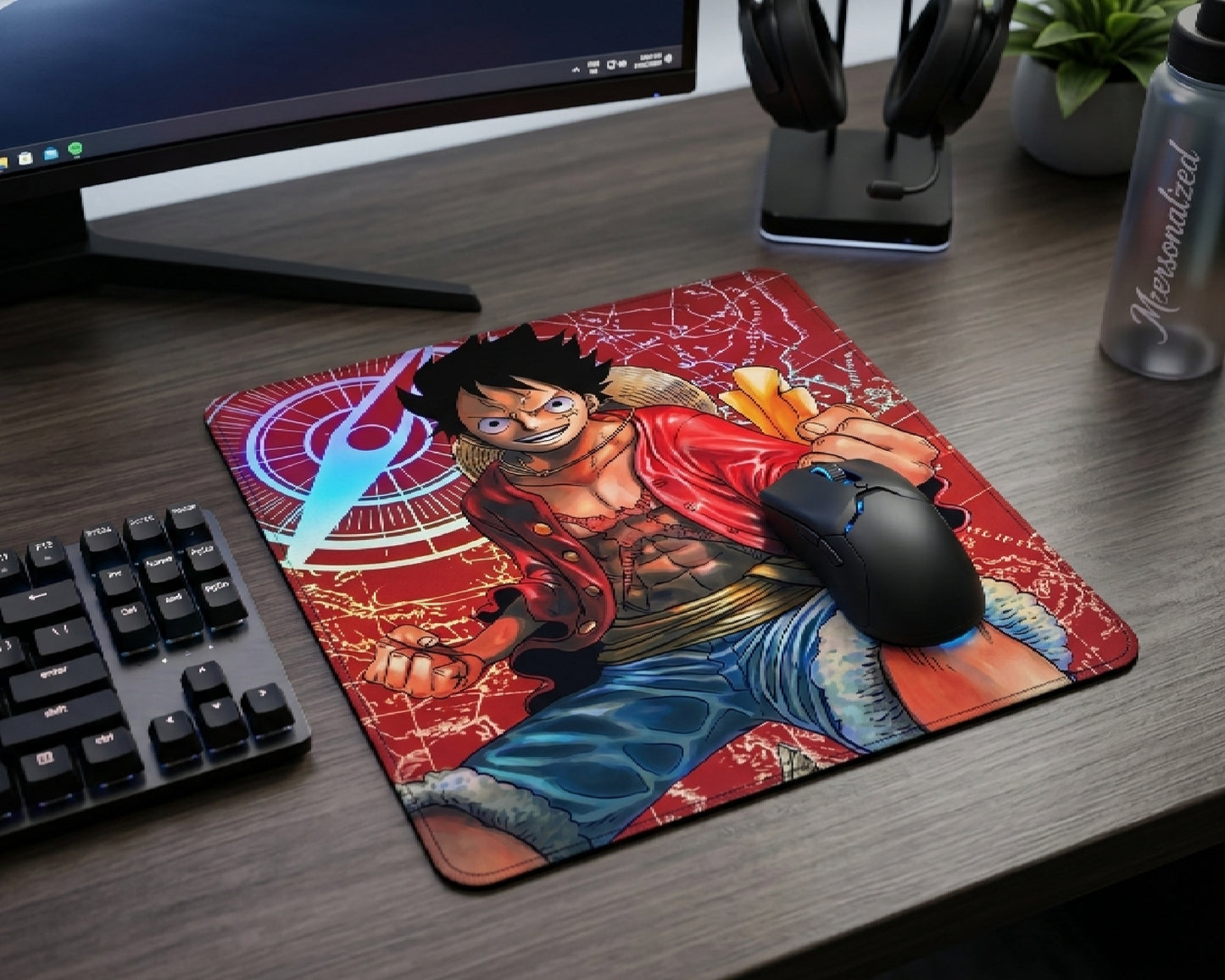 One Piece Monkey D. Luffy anime mouse pad on a modern gaming desk setup with mechanical keyboard, gaming mouse, headphones, and dark wood aesthetic