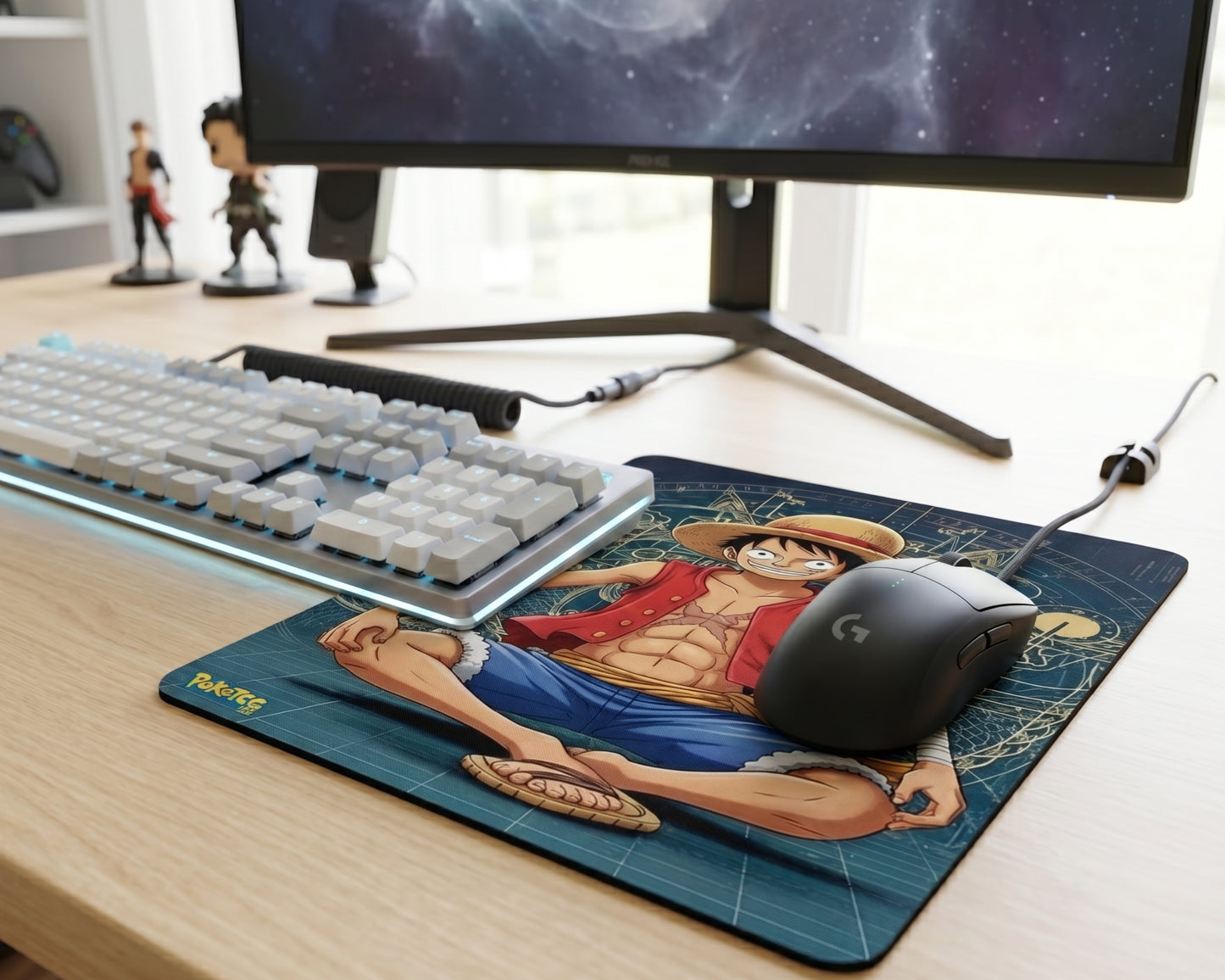 One Piece Luffy anime gaming mouse pad placed under white mechanical keyboard and black gaming mouse on wooden desk
