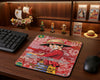 Monkey D. Luffy anime trading card style mouse pad displayed on a premium wooden desk with One Piece collectibles, figurines, graded cards, and gaming setup decor