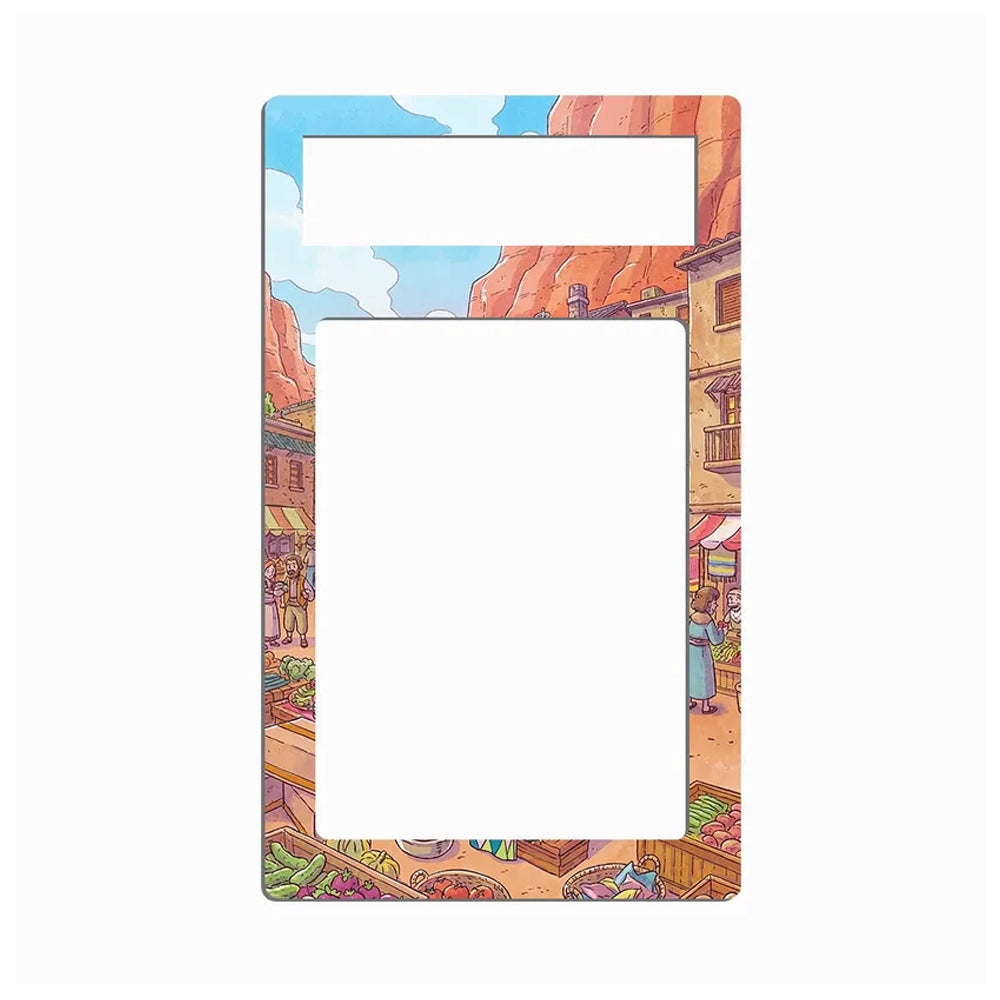 A rectangular picture frame with rounded corners, featuring a colorful cartoon-style desert market illustration printed around the border. The frame has a top mounting slot and a large central cutout for a photo.