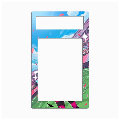 A rectangular decorative frame or magnet with a sports stadium illustration, featuring a blue sky, green field, and pink accents, shown on a plain white background.