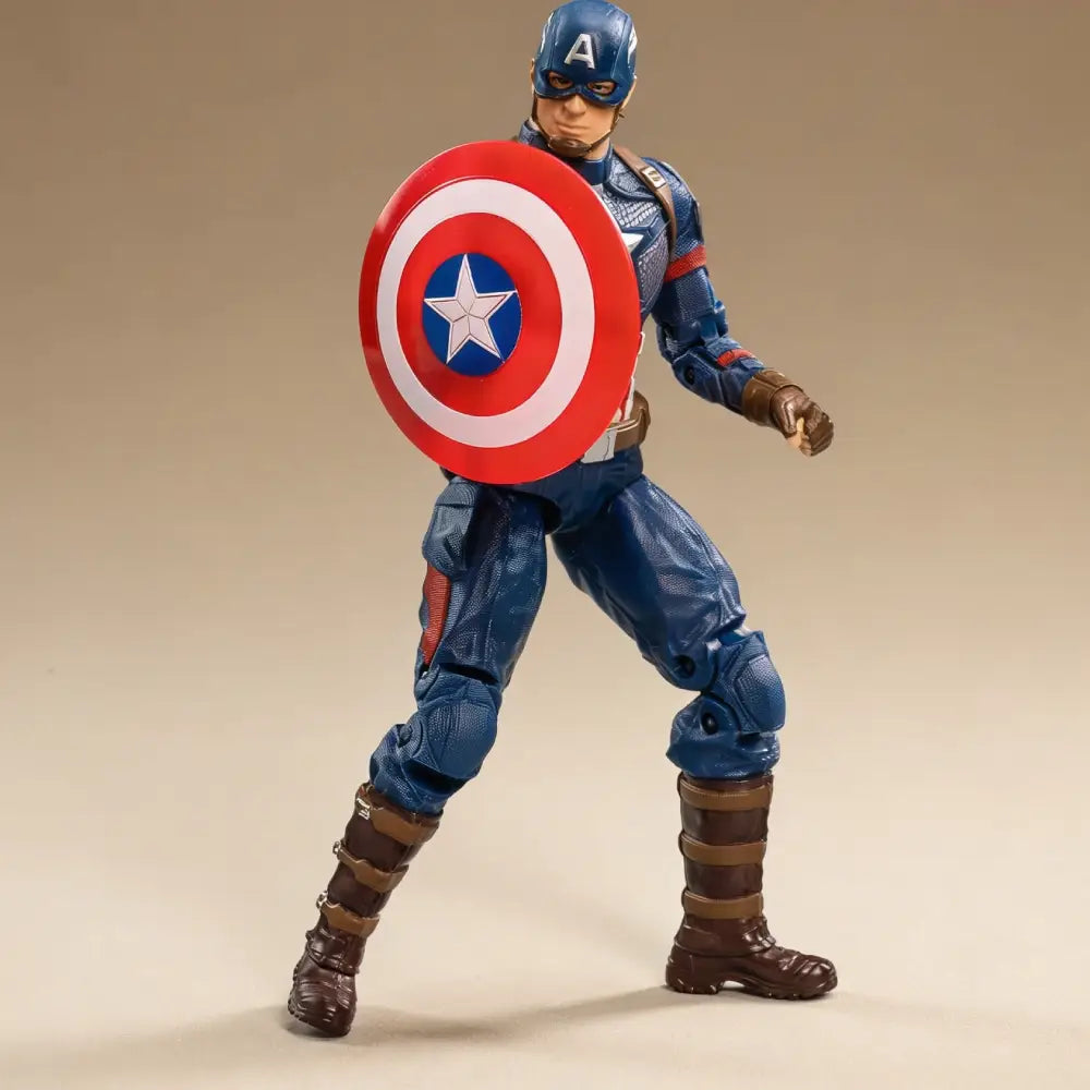 Action figure of a superhero in blue costume with red and white shield on beige background