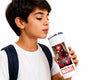 A young boy with a white t-shirt and dark backpack straps is shown drinking from a white tumbler with a Spider-Man graphic and a red Marvel logo, set against a solid white background.