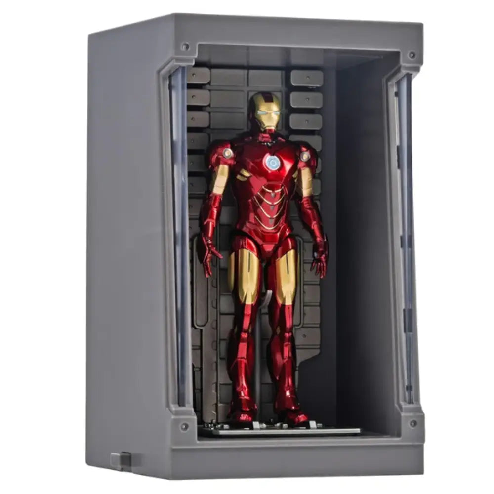 Red and gold superhero figure in a gray display case on a white background