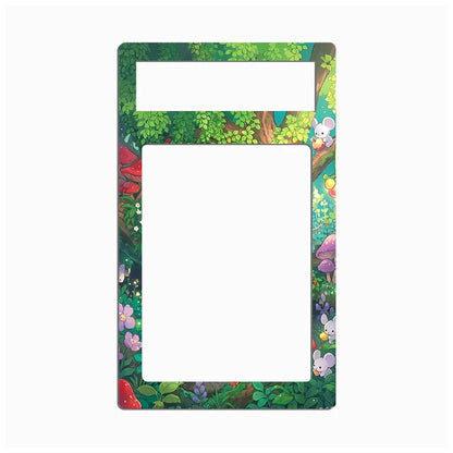 A rectangular decorative frame or plate with rounded corners, featuring a colorful forest illustration around the border and a blank white center cutout, shown on a light gray background.